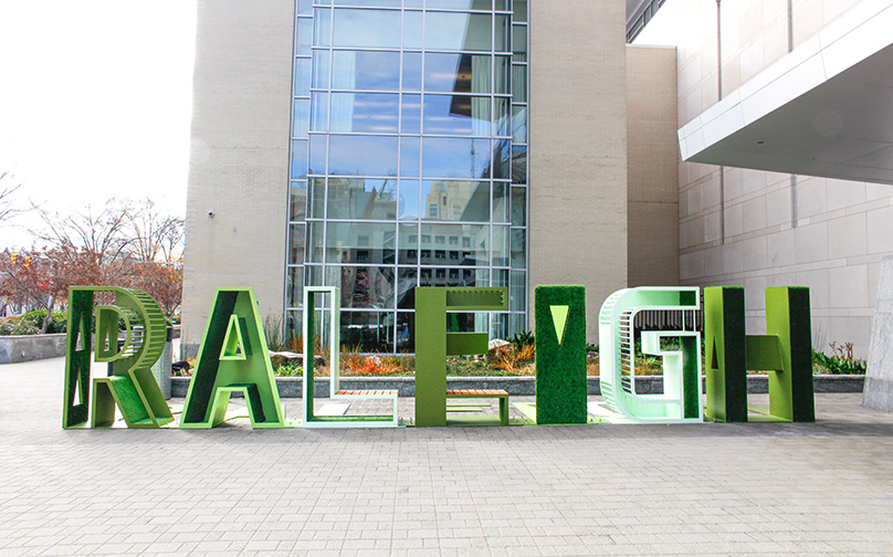 Green "RALEIGH" sign next to the Atlantic Union Bank Convention Center.