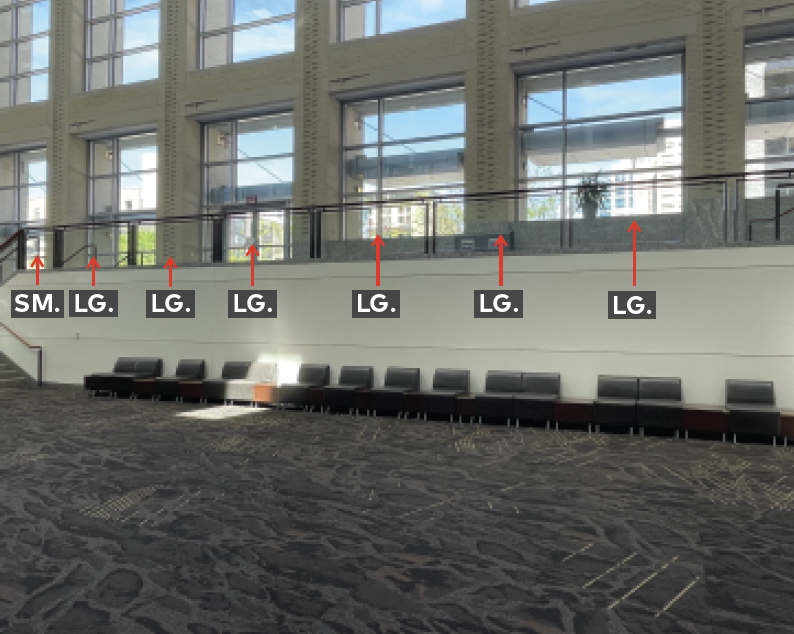 Middle mezzanine landing with railing and glass panels.