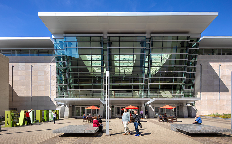 View of the entrance to Atlantic Union Bank Convention Center with people gathered and walking around.